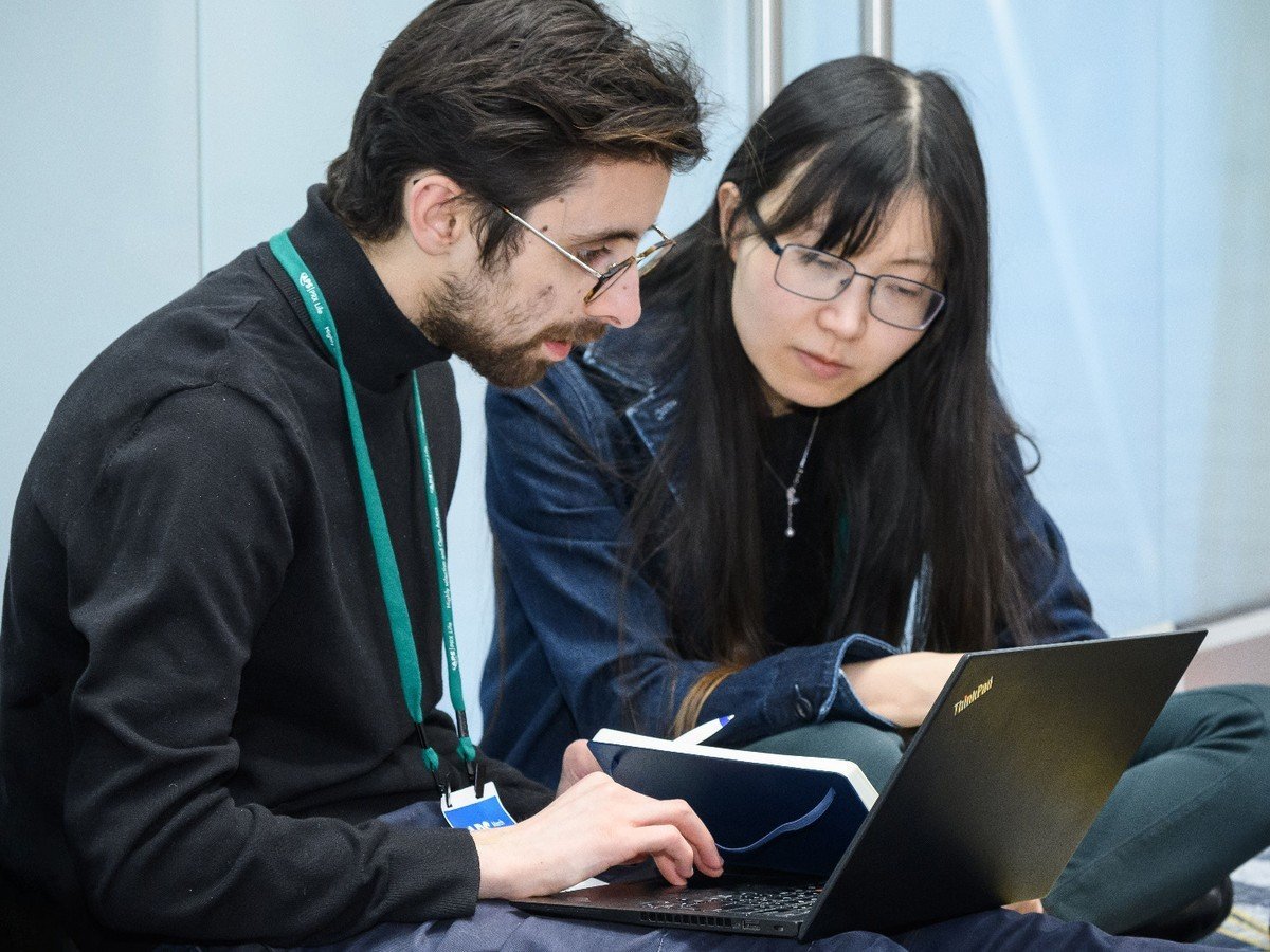 Two people looking at a computer together