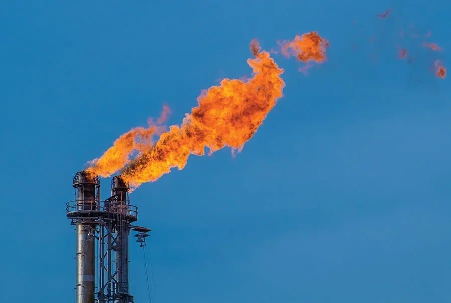 gas flare burns at a petroleum refinery