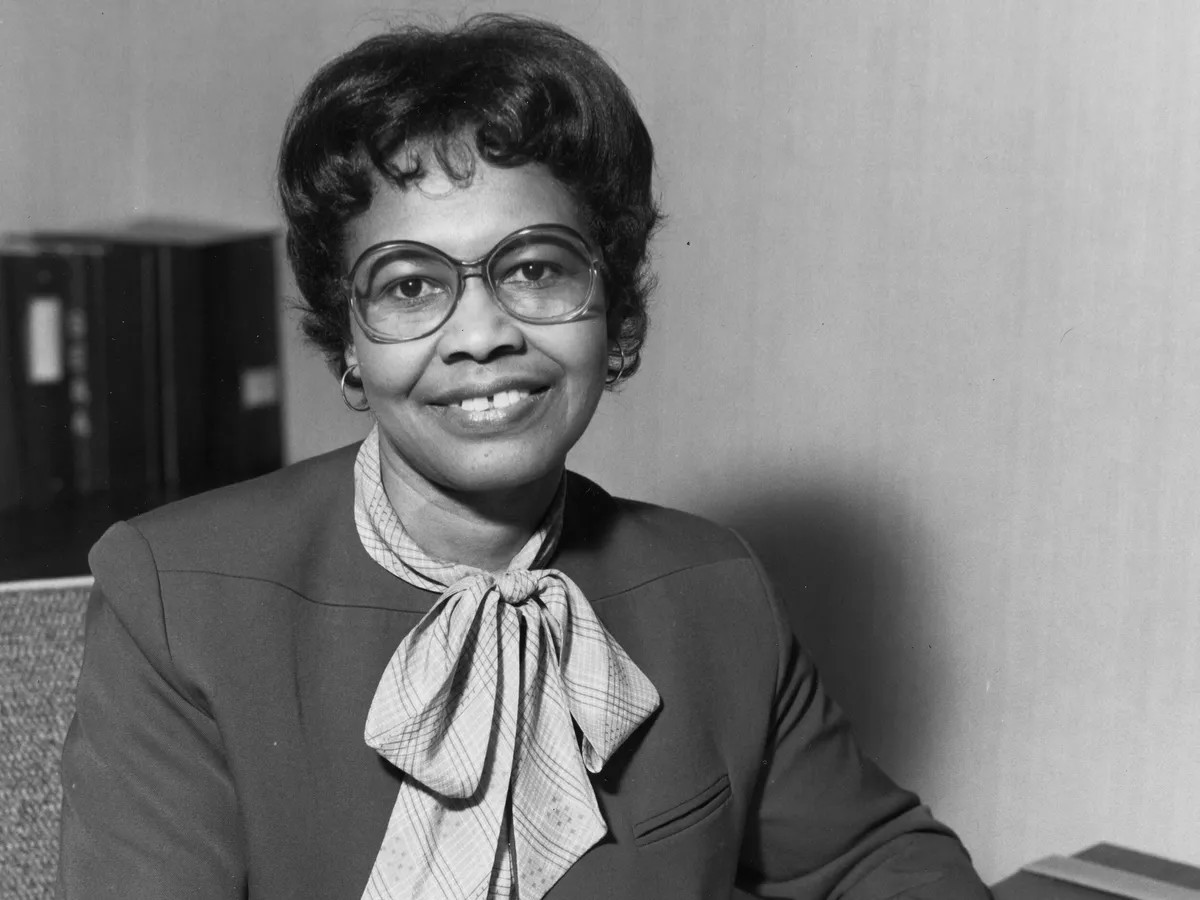 Gladys West seated at her desk