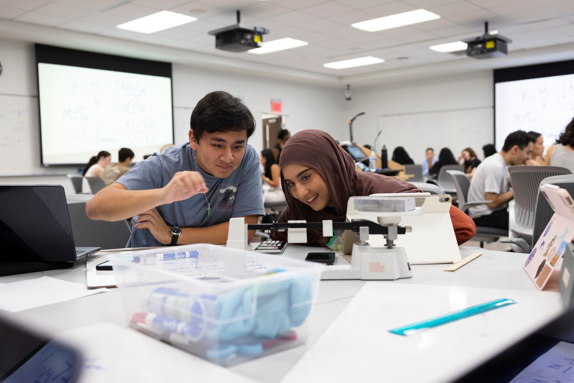 Two students working together in a physics lab