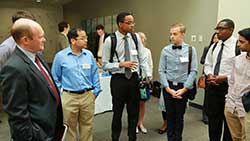 U.S. Sen. Chris Coons (D-DE) talks with students during a reception