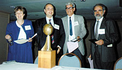 orum of Physics and Society Chair Ruth Howes presented the Forum Award (now the Burton Forum Award) in 1992 to (L-R) Fernando Barros, Luis Maspari, Alberto Ridner and Luis Rosa, who successfully worked with their governments to renounce nuclear weapons and to mutually inspect their nuclear facilities.