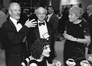 gala11.jpg - 11788 Bytes Emory University's Sid Perkowitz admires the fashionably 'retro' bowtie of APS Associate Executive Officer (and APS News editor) Barrett Ripin, while Marilyn Ripin looks on. Sara Schechner, curator of the Physics Works! and APS History exhibits, enjoys conversation at the table.