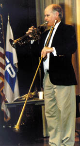 Brian Holmes employs various brass instruments to demonstrate the basic physics principles behind them.