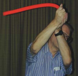 Vigorously twirling the plastic tube is James Watson, of Ball State University, who with his wife Nancy led a workshop on the physics of toys at the High School Physics Teachers’ Day held in Indianapolis as part of the March meeting. Each participant in this workshop received one of these tubes and about thirty other inexpensive toys that students can use for informal physics learning.