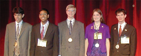 Victorious members of the US Physics team line-up with their medals on display