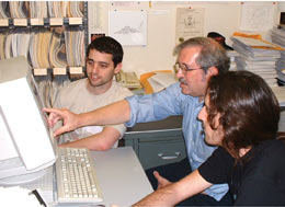 Michael Peskin (center) and colleagues use the miracle of electronic publishing to bring to their desktop a classic 1969 paper by Kenneth Wilson on the operator product expansion.