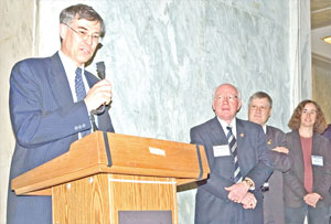 APS Fellow and member of Congress Rush Holt (D-NJ) addresses the crowd while APS Fellow and member of Congress Vernon Ehlers (R-MI) looks on, together with event organizers Charles Clark of NIST and Susan Coppersmith of the University of Wisconsin.