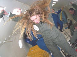 Teacher Lori DiLisi of Beaumont High School in University Heights, Ohio flies through the air with the greatest of ease in the weightless environment aboard NASA's reduced gravity C-9 airplane.