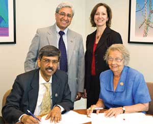 Signing the memorandum of understanding are IUSSTF Executive Director Arabinda Mitra (left) and APS Executive Officer Judy Franz (right). Standing guard are Kamal Kant Dwivedi (left), 