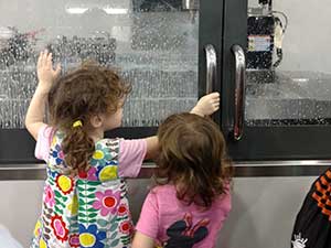 Kids watching milling machine