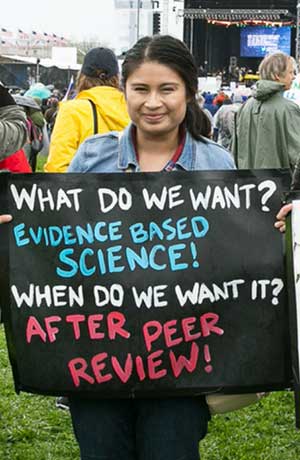 woman holding up science sign