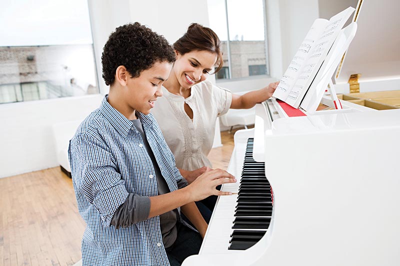 child taking piano lessons