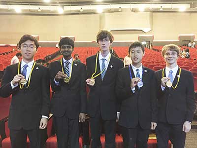 US Physics Olympiad Team showing gold and silver medals